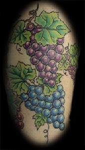 Colourful grape vine tattoo