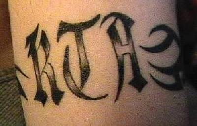 Tribal lettering tattoo