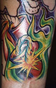 Flaming explosion cartridge tattoo in colour