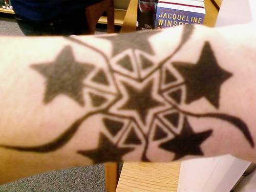 Black star tracery tattoo