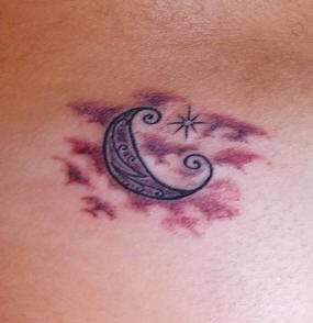 Moon crescent in clouds tattoo