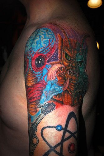 Blue and red alien creatures tattoo