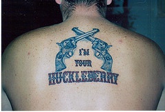 el tatuaje detallado de las pistolas cruzadas hecho en la espalda