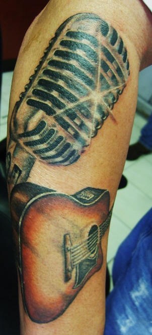 Shining microphone & guitar music forearm tattoo picture