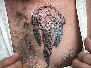 Indian talisman with feathers tattoo on chest
