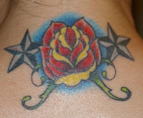 Nautical star and red rose tattoo