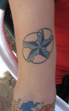 Blue and black star tattoo