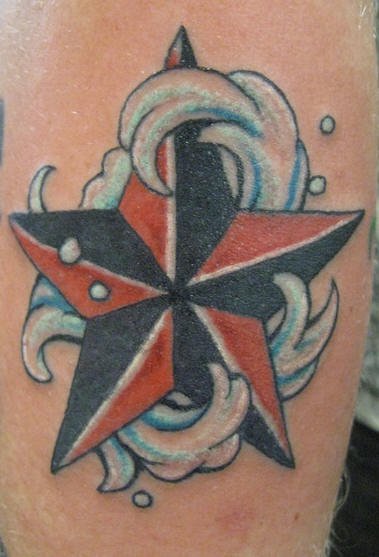 Red and black star in sea waves tattoo