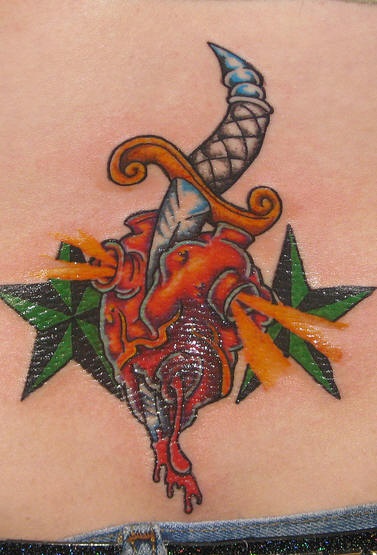Curved dagger in heart coloured tattoo