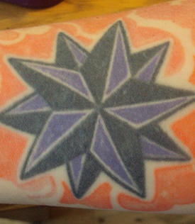 Purple and black decagonal star tattoo