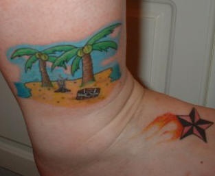 Flaming star and desert island tattoo