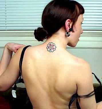 Girly flower tattoo on neck