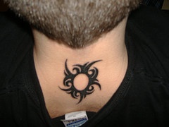 Black tribal sun tattoo