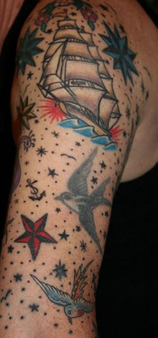 Old school sleeve tattoo of ship, birds and stars