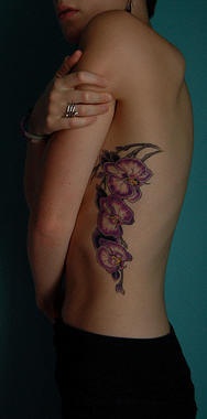 Pink orchid flowers tattoo on side