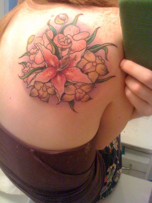 Orchid and yellow flowers tattoo on shoulder