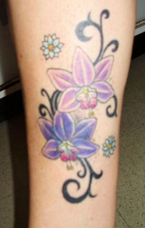 Orchid flowers and tribal tracery tattoo