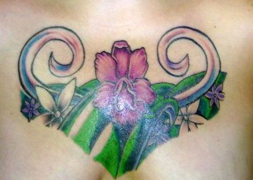 Orchid flowers tracery coloured tattoo on chest