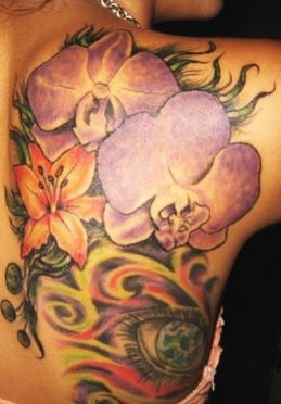 Large colourful flowers and eye tattoo