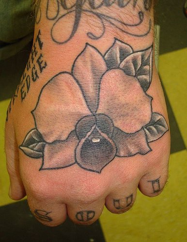 Black orchid flower hand tattoo