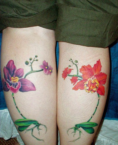 Orchid flower tattoos on both legs