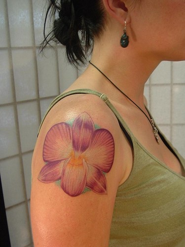 Pink orchid flower tattoo on shoulder