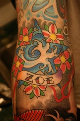 Colorful oschool tattoo with wave in star, flowers and name inscription