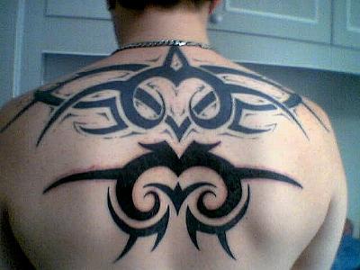 Traditional back tattoo with black signs