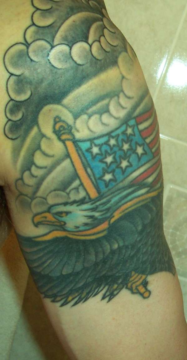 Patriotic eagle with flag in clouds tattoo