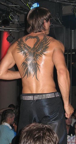 Black ink phoenix tattoo on back