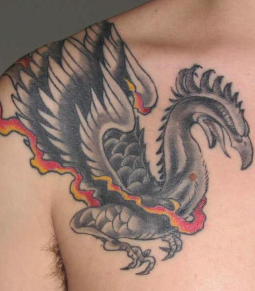 Black phoenix tattoo on chest
