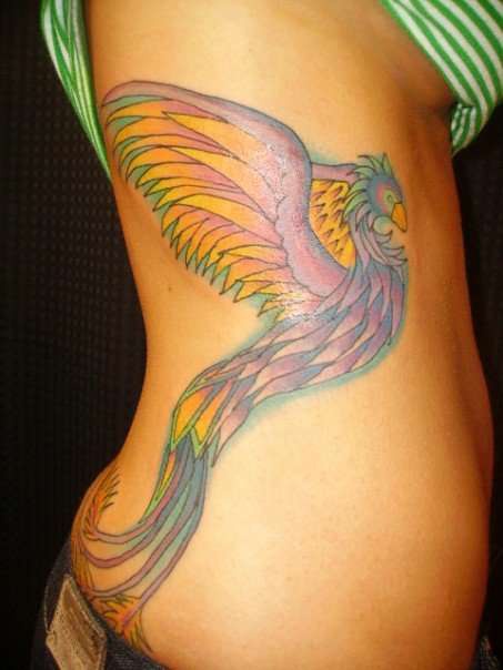 Colourful magic bird tattoo on side