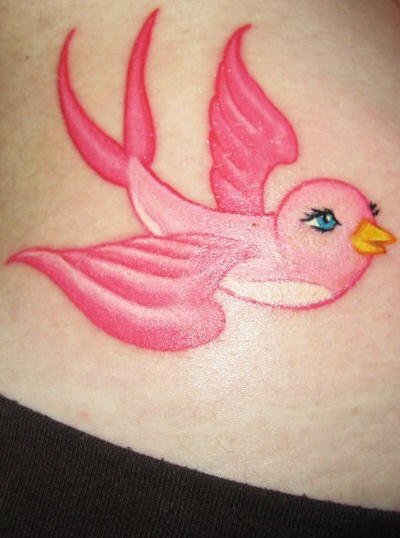 Flying, positive, pink bird hip tattoo