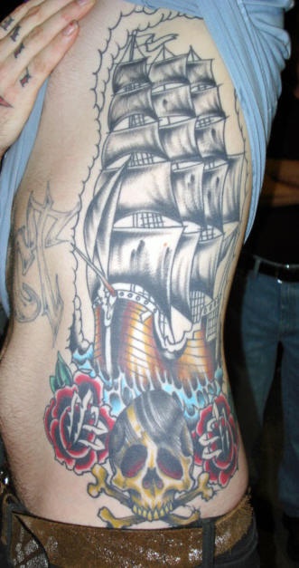 Ribs tattoo, large pirate ship in see , skull