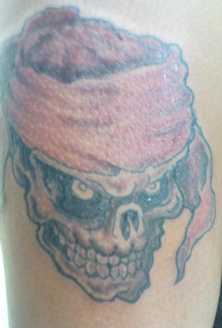 Pirate skull in flag tattoo