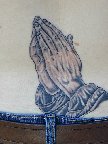 Detailed praying hands tattoo