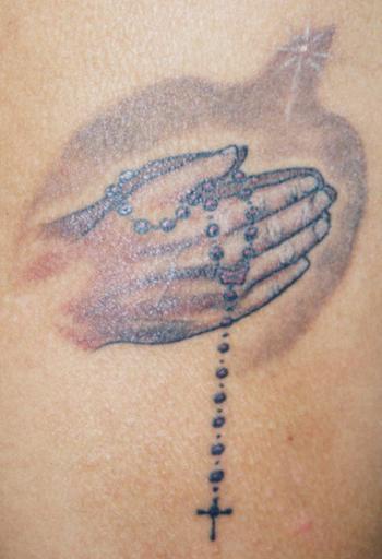 Young Praying hands tattoo