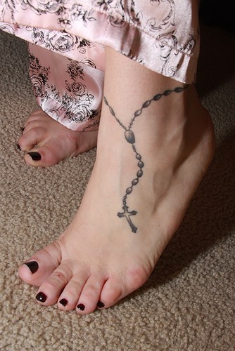 Rosary beads tattoo on female ankle
