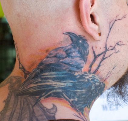 Detailed raven on tree neck tattoo