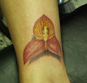 Realistic orchid flower tattoo on wrist