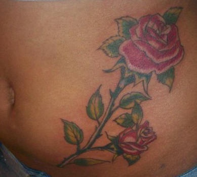 Stomach tattoo, red rose and bud