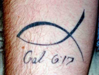el tatuaje minimalista de ichtys con la cita biblica de los galatas 6:17