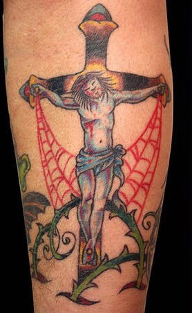 Jesus on cross in thornes and web tattoo