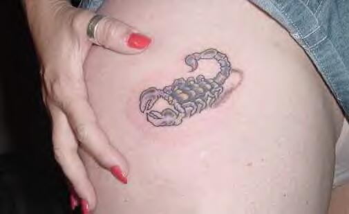 Black scorpion tattoo on tummy