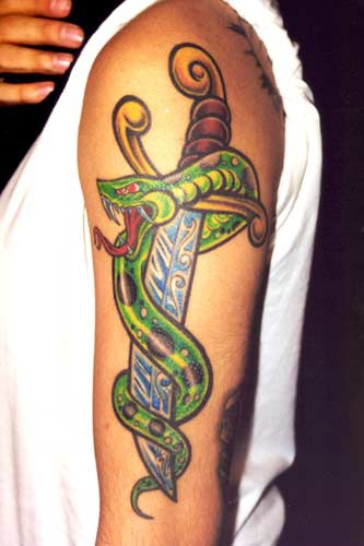 Green snake around dagger tattoo