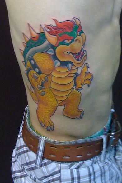 Rib tattoo, cartoon, colourful yellow dinosaur