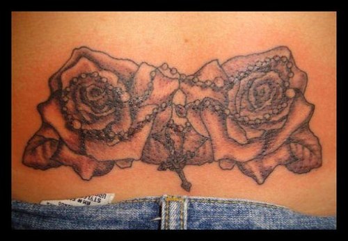 Rosary and roses lower back tattoo