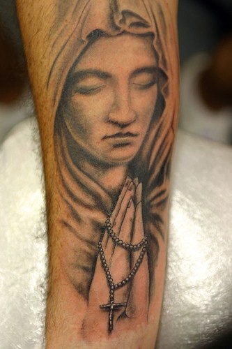 Angel sculpture with rosary tattoo