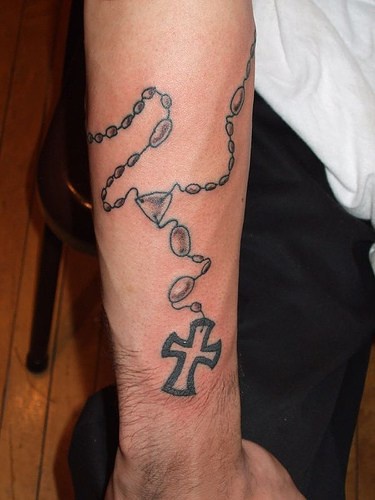 Black rosary armband tattoo on wrist