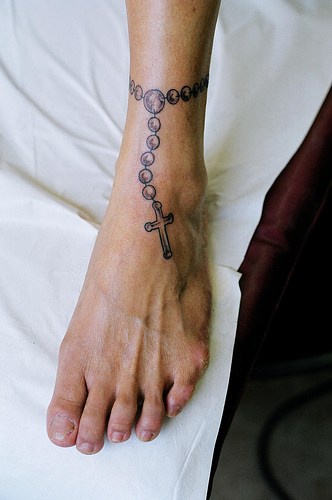 Simple rosary tattoo on leg